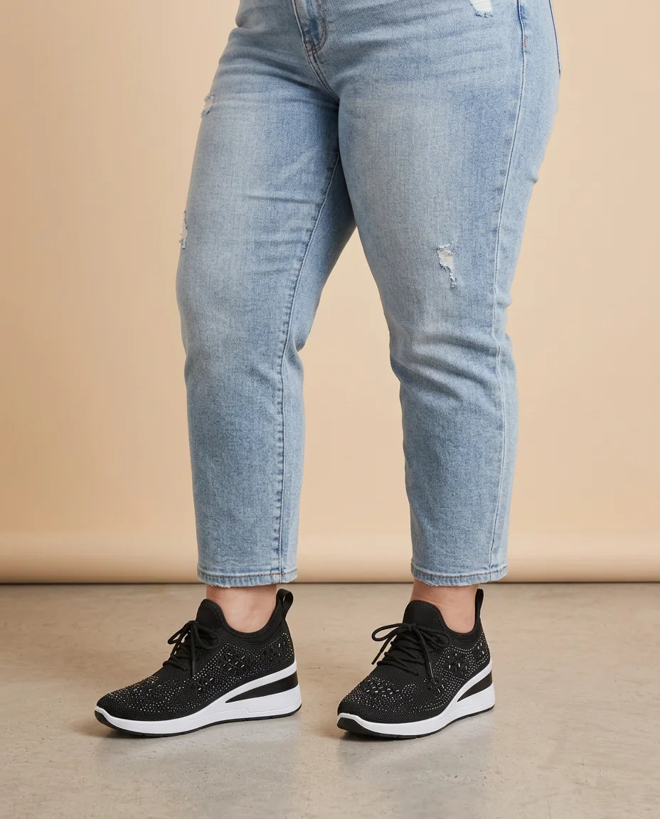 Rhinestone Mesh Wedge Sneakers worn by a woman with curves