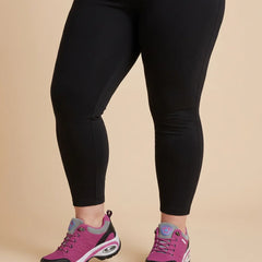 Cushioned Lace-Up Walking Sneakers worn by a woman with curves