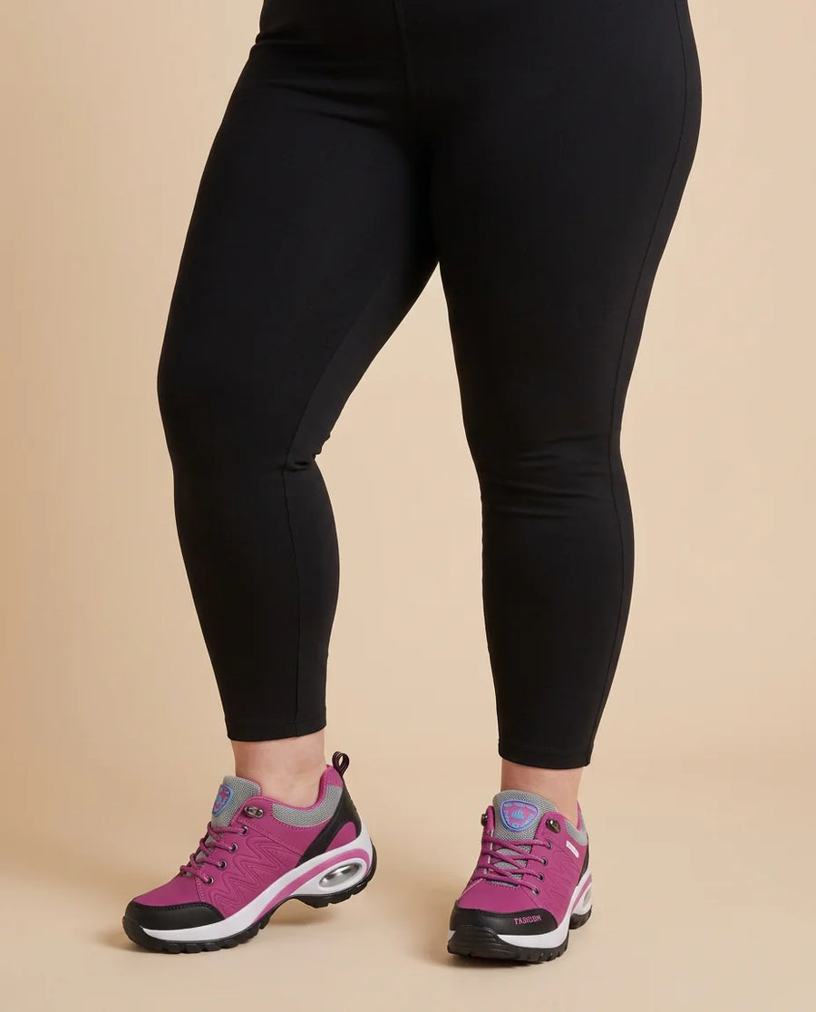 Cushioned Lace-Up Walking Sneakers worn by a woman with curves