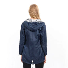 Sabrina Hooded Rain Jacket in Navy, back view on model