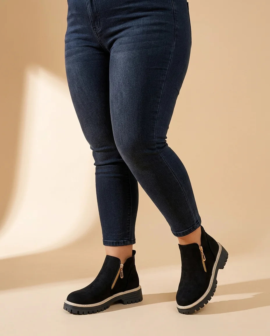 Gold Zip Lug Sole Ankle Boots worn by a woman with curves