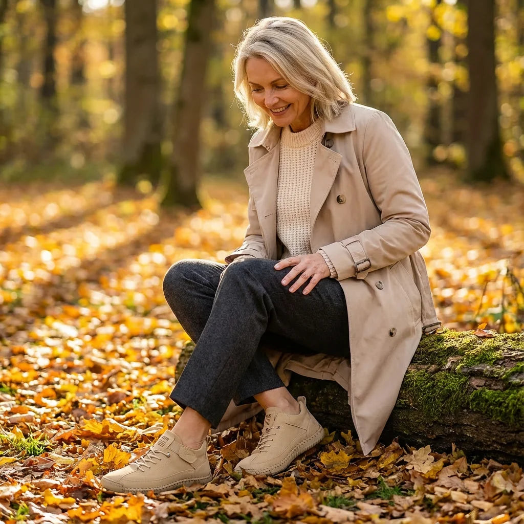 Woman in an autumn park tying her Rosie sneakers