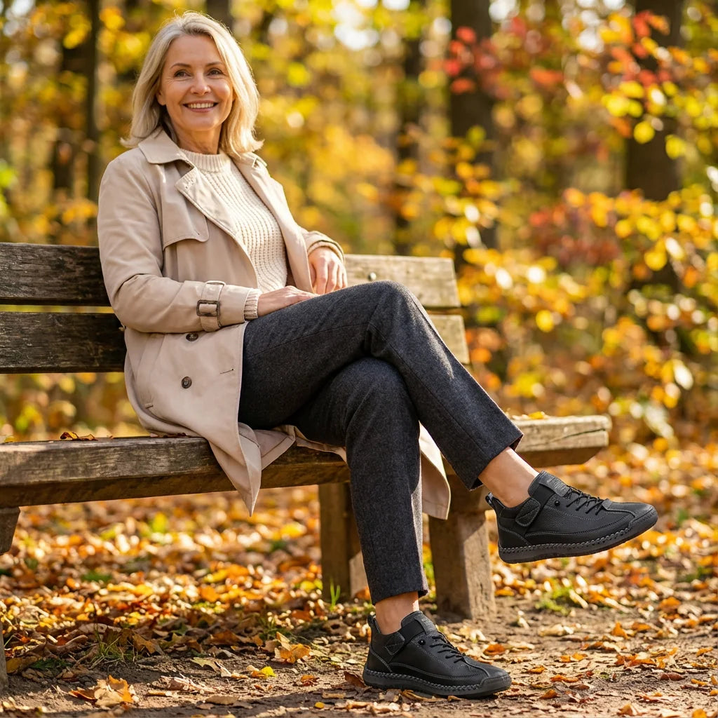 Rosie sneakers in black, worn with dark trousers