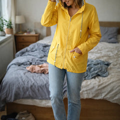 Solange hooded rain jacket in Yellow, worn