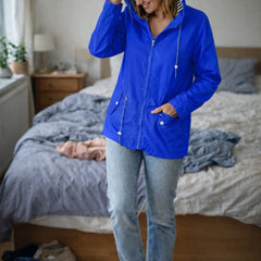 Solange hooded rain jacket in Blue, worn