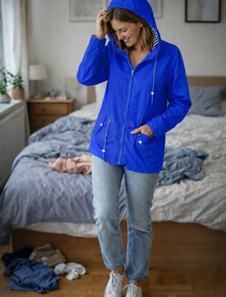 Solange hooded rain jacket in Blue, worn
