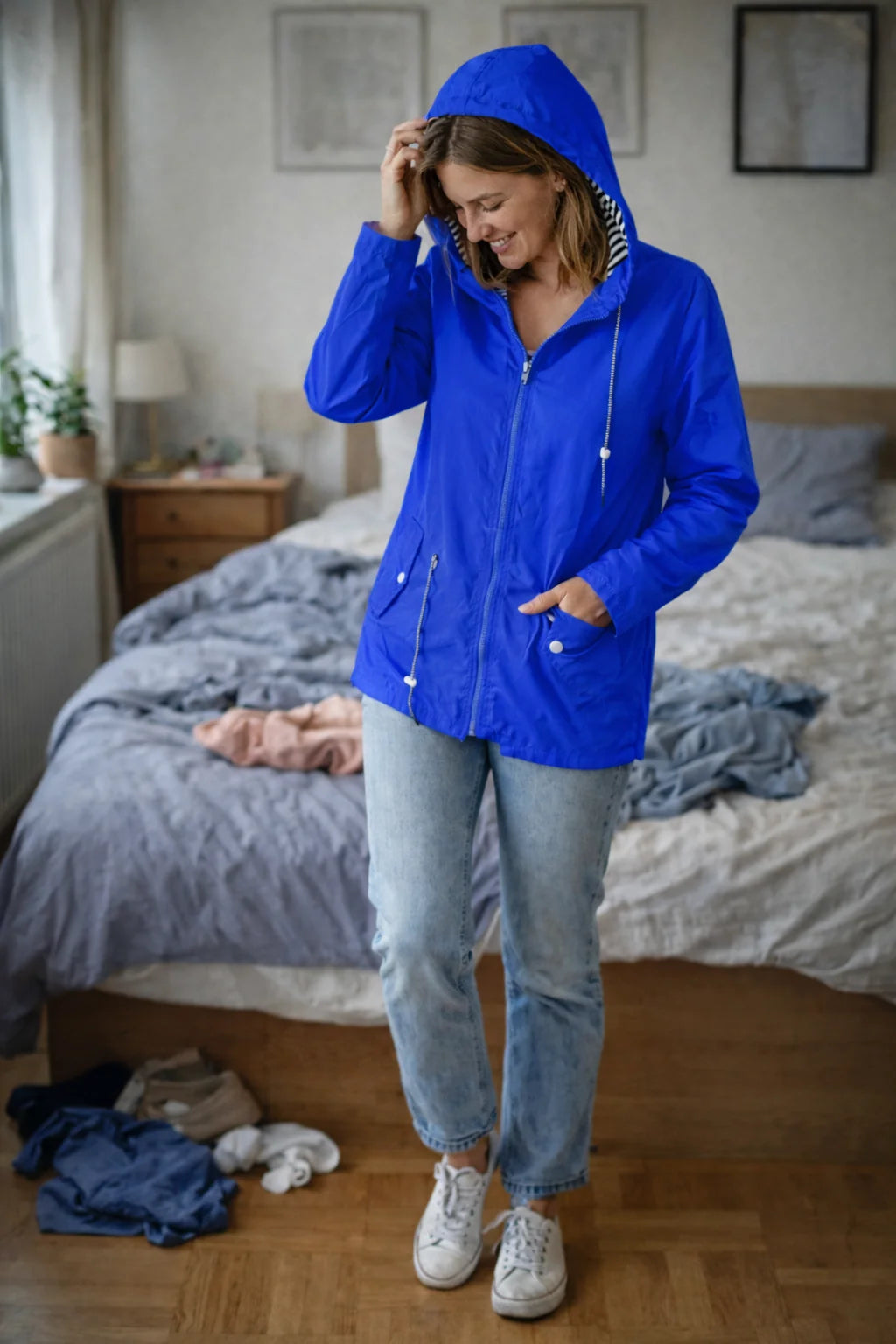 Solange hooded rain jacket in Blue, worn