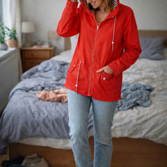 Solange hooded rain jacket in Red, worn