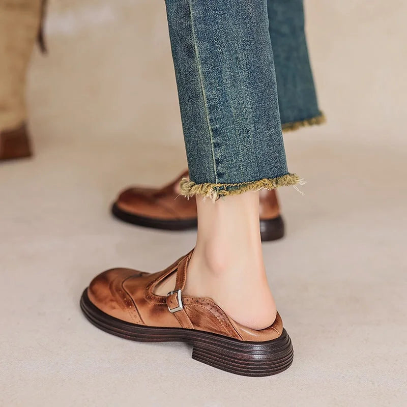 Woman wearing the Verda T-strap shoes in brown, side view